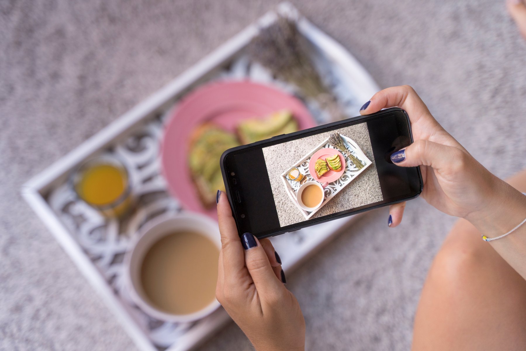 Young Woman Taking Photo of Breakfast Tray 